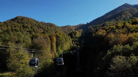 Exciting aerial view on funicular cabins moving on the cable road. fall Stock Footage 204010840