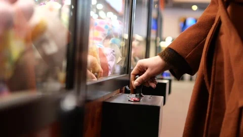 Exciting claw machine adventure in a lively arcade Stock Footage 338378257