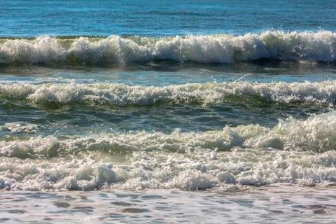 Exciting harmony with sea waves rolling down to the shore. Stock Photos