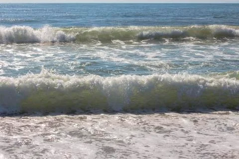 Exciting harmony with sea waves rolling down to the shore. Stock Photos