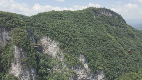 Exciting ride on zip line over Grand Canyon in summer, Zhangjiajie, Hunan, China Stock Footage 328359370
