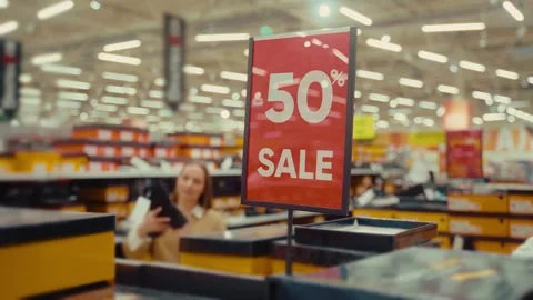 Exciting shopping experience with 50 percent off sale at local store during busy Stock Footage 293673462