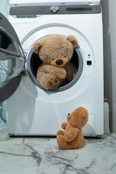 An Exciting Teddy Bear Adventure Inside the Washing Machine Full of Colorful Fun Stock Photos