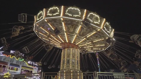 An Exciting Twirly Ride Spinning at the Fair/Carnival in Slow Motion Stock Footage