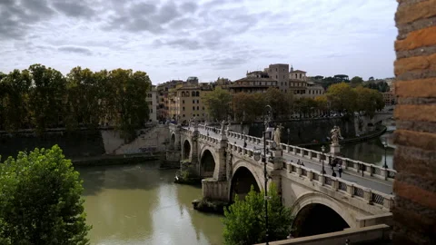 The exciting view of the Bridge with statues of Angels across the Tiber river Stock Footage 144671501