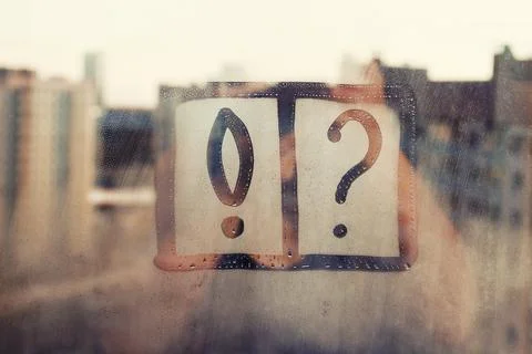 Exclamation mark and question mark hand drawn in frames on foggy glass on city Stock Photos
