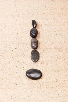 Exclamation mark drawn with pebbles on the beach Stock Photos