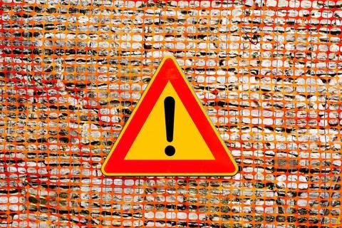 An exclamation point on a yellow background, in a red triangular sign. The... Stock Photos