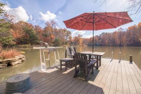  Excluded dock overlooking a beautiful fall landscape on bright sunny fall day  Stock Photos