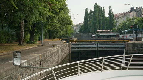 Excursion boat approaches closed metal gates of Smichov canal lock in Prague Stockbeeldmateriaal 341667253