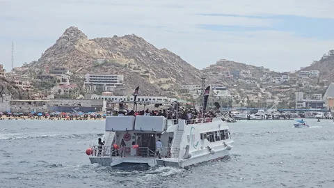 Excursion boat carrying passengers enjoying fun voyage experience on the ocean Stock Footage 329145967