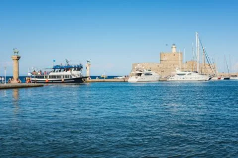 Excursion boat coming back into Mandraki harbor in City of Rhodes (Rhodes, Gr 写真素材