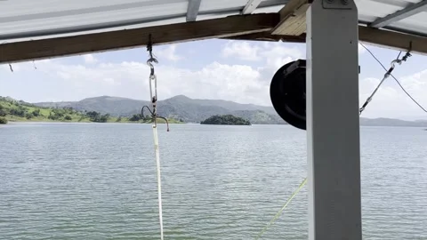 Excursion boat driving through the reservoir Presa de Hatillo near Cotui in the Stock Footage 296569742