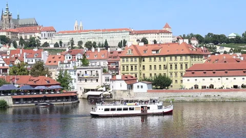 An excursion boat sails along the river with the old district of Prague in the b Video stock 311931219
