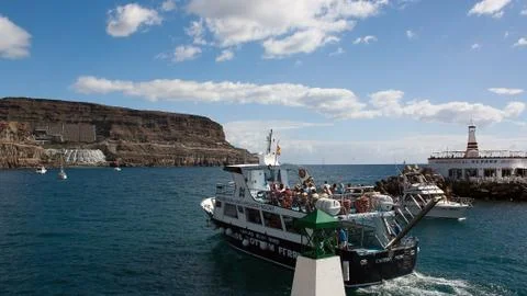 Excursion boat when leaving the port of Puerto Mogan on Gran Canaria Stock Photos