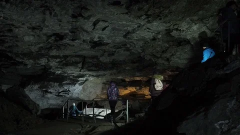 Excursion into dark ice cave in winter. Tourism in Russia, speleology concept Vídeos de archivo 107609805
