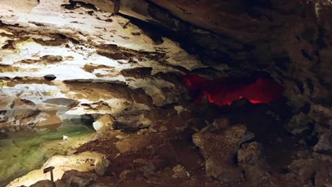 Excursion to the dark ice cave in winter. Underground large stone cave.  Vídeos de archivo 250824987