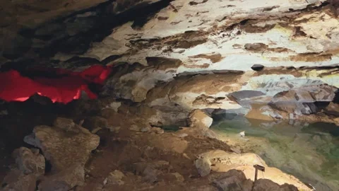 Excursion to the dark ice cave in winter. Underground large stone cave.  Vídeos de archivo 250861019