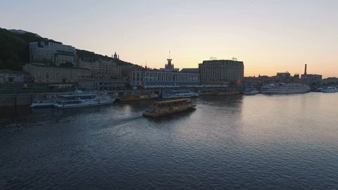 Excursion passenger ship sails to the port of the old European city at sunset Stock Footage 90359952