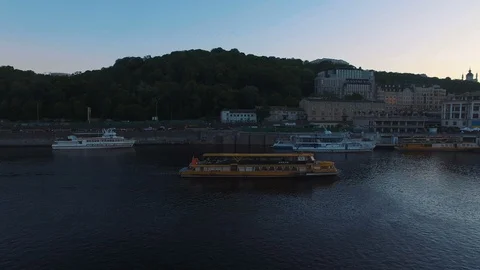 Excursion passenger ship sails to the port of the old European city at sunset Stock Footage 90361247