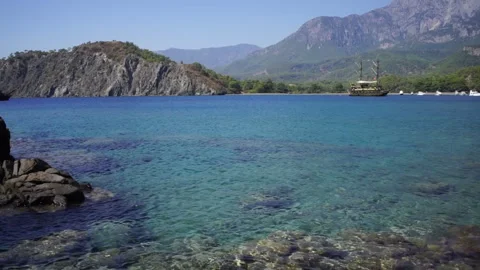 An excursion pirate old wooden ship sails, carrying tourists on a tour to a Stock Footage 245009244