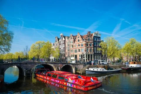 The excursion ship on the canal in Amsterdam Stock Photos