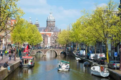 The excursion ship on the canal in Amsterdam Stock Photos