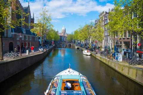 The excursion ship on the canal in Amsterdam Stock Photos