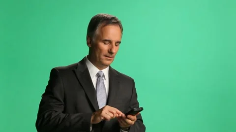 Exec on phone - makes date - Greenscrn - Med Video stock 8137860