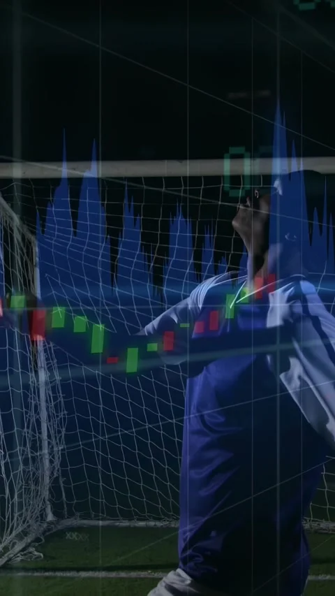 Executing bicycle kick, soccer player in blue kit at night near goal net with Stock Footage 331168605