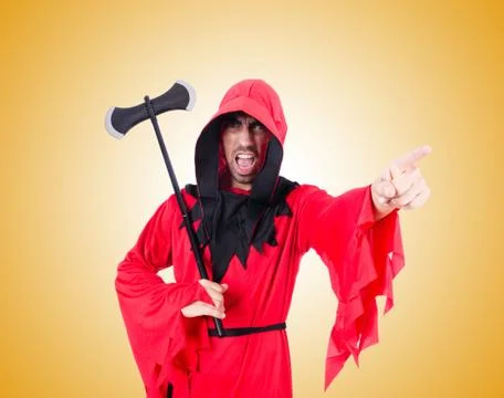 Executioner in red costume with axe against the gradient Stock Photos