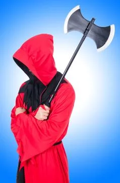 Executioner in red costume with axe on blue Stock Photos