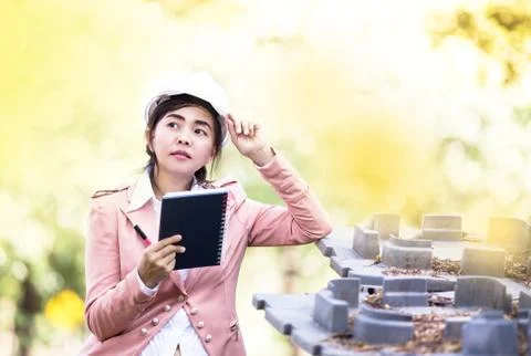 Executive Asian engineer woman checking construction site Stock Photos
