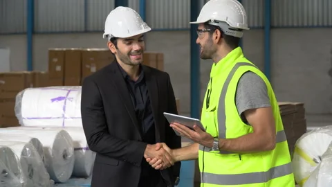 Executive business man handshake with warehouse manager in large warehouse. c Stock Footage 144268236