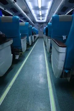 Executive class train interior with blue seats, armrests, luggage racks, mo.. Stock Photos