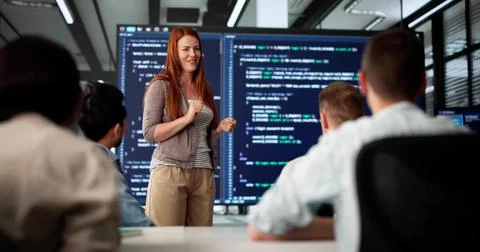 Executive Coder Gives Presentation To Diverse Team In Boardroom 스톡 사진