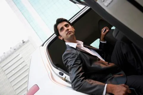 Executive coming out of a car Stock Photos
