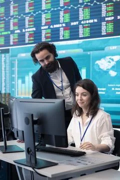 Executive consultant and associate discuss about performance metrics Stock Photos