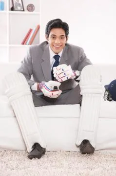 Executive with cricket gear smiling Stock Photos