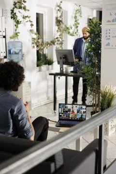 Executive discussing strategy with remote team on laptop screen Stock Photos