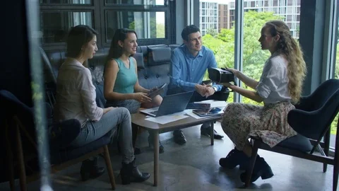 Executive explaining about vr headset to colleagues in office Stock Footage 75452444