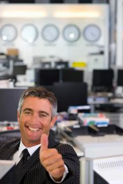 Executive gesturing thumbs up Stock Photos