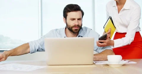 Executive getting frustrated while working at his desk Stock Footage