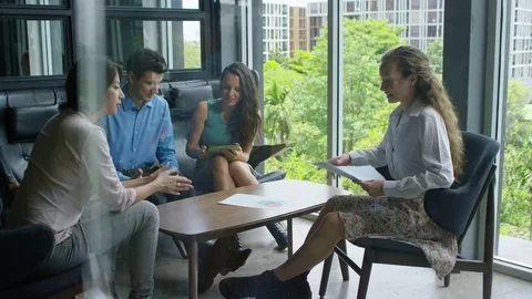 Executive giving documents to colleagues in office Stock-Footage 75451530