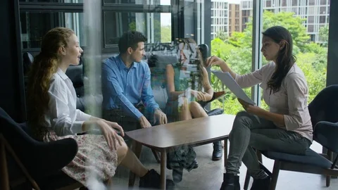 Executive giving documents to colleagues in office Stock Footage 75451558