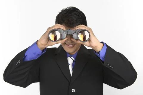 Executive holding binocular and looking through it MR#687M Photos