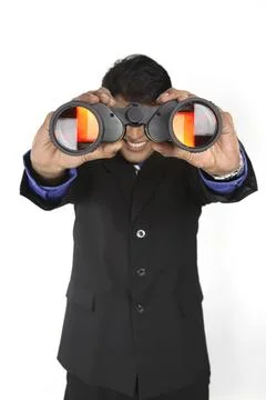 Executive holding binocular and looking through it MR#687M Stock Photos