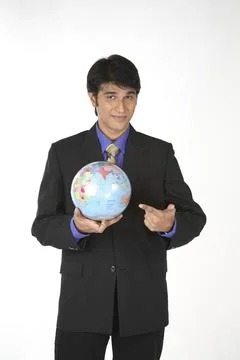 Executive holding globe in hand showing India MR#687M 写真素材