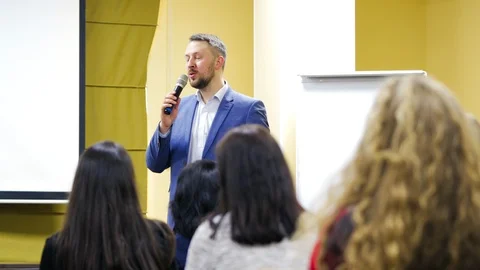 Executive leader is talking into the microphone at public seminar. Stock Footage 108580309