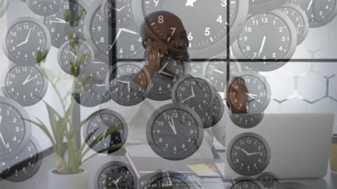 Executive making deadline call reaching for smartphone with clock overlays Stock Footage 318240525